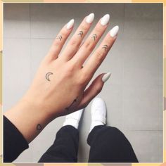 a woman's hand with two different tattoos on it