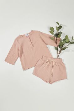 "Made with incredibly soft and airy cotton muslin, this 3/4 length-sleeved Henley features buttons down the front Too with Drawstring Shorts set. Product Details - Round Neck / 3/4\" Sleeves / Buttons tab - Elastic Waistband / Drawstring - Garment Pulls on Size & Fit - Fit true to size - Very Soft & relaxed fit Materials & Care - Pre-Washed - 100% cotton - Machine Wash cold / Line Dry There may be color differences depending on the resolution of your device." Spring Cotton Sets With 3/4 Sleeve, Pant And Top Set, Retro Clothes, Summer Neutrals, Kid Clothing, Baby Fits, Baby Girl Boy, Top And Pants Set, Unisex Baby Clothes