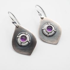 Sterling silver dangle earrings featuring a genuine 5mm Amethyst stone with a drop length of 40mm (1.57"). Perfect for everyday wear with any outfit, combining boho and chic styles. All of our pieces are made to order, so please allow for roughly 1-3 days for us to create your unique item. While we strive to make our products match the photos as closely as possible, please keep in mind that there may be slight variations. If you want to see more of our handmade earrings, please visit our Etsy sh Purple Teardrop Metal Earrings, Modern Purple Dangle Jewelry, Purple Sterling Silver Teardrop Dangle Earrings, Modern Purple Gemstone Earrings, Handmade Purple Sterling Silver Earrings, Modern Amethyst Earrings As Gift, Purple Modern Sterling Silver Earrings, Modern Purple Sterling Silver Earrings, Modern Amethyst Gemstone Earrings