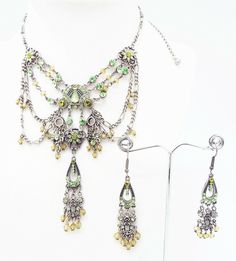 DESIGNER INSPIRED  16 in GREEN MULTI CRYSTAL  SILVER VICTORIAN  JEWELERY SET NEW Up for your consideration is a GREEN multi crystal unique filigree Victorian Chandelier Necklace and Earrings Jewelry Set. ALL SET IN SILVER TONE METAL  Necklace measures 12.5 in with a 3.5 in EXTENDER Silver figaro chain with lobster claw closure   center station measures 4  in by 3.5 in with crystal drops  French Wire Hook Pierced Chandelier Earrings measure 2 1/2 in by 1/2 in Great gift Idea. Please ask all questions prior to ordering! Victorian Chandelier, Chandelier Necklace, Silver Figaro Chain, Metal Necklace, Figaro Chain, French Wire, Crystal Drop, Necklace And Earrings, Metal Necklaces