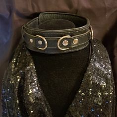 a black leather collar with silver sequins