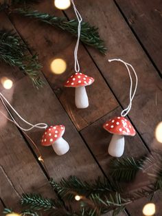 some little mushrooms are hanging from the christmas tree