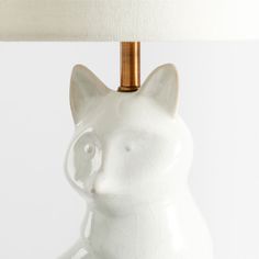 a white cat lamp sitting on top of a table