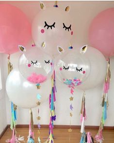 balloons with unicorn faces and eyelashes on them