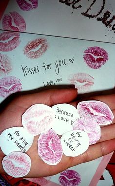 a person's hand is holding several kisses for you stickers