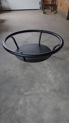 a black table sitting on top of a cement floor