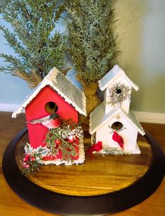 two bird houses are sitting on a table