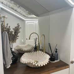 a bathroom sink sitting under a mirror next to a faucet