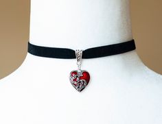 This choker is made from black velvet ribbon and a red, heart shaped pendant embellished with antique silver filigree. - The choker measures 12 inches/30.5cm in length and 0.4 inches/10mm wide - The pendant is approximately 1 inch long and 0.75 inch wide - The choker closes with a lobster claw clasp at the back - One size fits most (for a neck of about 12.5 inches). there is a 2 inch extension chain at the back to accommodate larger neck sizes SHIPPING: Default shipping is by regular mail, which Victorian Heart Pendant Jewelry For Valentine's Day, Red Locket Jewelry For Valentine's Day, Ornate Filigree Jewelry For Valentine's Day, Vintage Choker Jewelry For Valentine's Day, Ornate Pendant Jewelry For Valentine's Day, Gothic Heart-shaped Wedding Jewelry, Ornate Necklace For Valentine's Day Gift, Gothic Filigree Necklaces For Gifts, Red Gothic Jewelry With Heart Charm