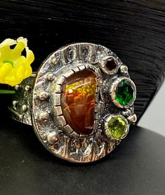 Mexican Fire Agate Gemstone ring in sterling silver size 10 1/4 Materials: Silver 925,  Mexican Fire Agate, Peridot, Lab Grown Emerald, Garnet Face of the ring:  Height-25mm, Width-25mm, Band-12-8mm Unique Handcrafted One-of a-kind Design Ring Each Piece of Jewelry in my Collection is Absolutely One of a Kind! When you start wearing a piece of my jewelry you will fall in love with it more and more each day and feel that good Energy and Love that I pass into it while creating this piece of Art. A Unique Sterling Silver Opal Ring With Natural Stones, Unique Opal Ring With Natural Stones For Anniversary, Artisan Silver Opal Ring With Multi-stone, Artisan Amber Gemstone Rings, Unique Carnelian Ring For Anniversary, Unique Collectible Rings With Natural Stones, Artisan Amber Ring Jewelry, Unique Silver Opal Ring With Multi-stone, Unique Carnelian Ring Jewelry