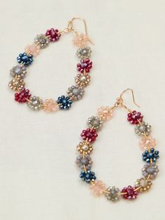 These beautiful dangle earrings feature an array of colorful glass beads, meticulously arranged to form charming floral designs. Flower-shaped Earrings With Colorful Beads For Party, Flower Shaped Earrings With Colorful Beads For Party, Colorful Beaded Flower Earrings For Party, Multicolor Flower-shaped Earrings With Dangling Beads, Multicolor Beaded Flower Earrings For Party, Party Flower Earrings With Colorful Beads, Dangling Bead Flower Earrings For Party, Multicolor Flower Charm Drop Earrings, Elegant Multicolor Czech Glass Beaded Earrings