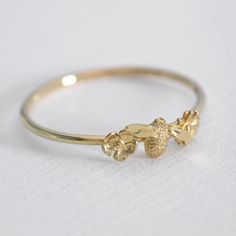 Product Description
An Itsy Bitsy Bee is framed by two flowers in our Bee and Floral Ring. Discover a special fine jewellery collection created in celebration of the 10th anniversary of Alex’s iconic Bumblebee Necklace! In 'The Beekeeper', flowers and leaves entwine to reveal miniature bees nestled within. Handcrafted from 18ct gold or platinum and illuminated with ethically sourced diamonds, 'The Beekeeper' is handcrafted in our London Studio. 
Product Details
Metal
18ct Solid Yellow, Rose & White Gold
Band Thickness
0.1 cm
Bee
0.8 cm by 0.4 cm
Product Code
TBR9 Bumble Bee Necklace, Two Flowers, Bee Ring, Fine Ring, Floral Ring, Custom Ring Designs, Jewellery Handmade, Exclusive Jewelry, White Gold Band