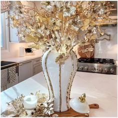 a white vase filled with flowers on top of a counter