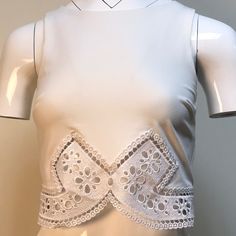 A Brand New Bebe White Cropped Tank Top With Floral Eyelet Cutouts! The Back Is Detailed With A Silver Zipper And The Bottom Lining Is Embroidered With A Beautiful, White Silk Flower Pattern/Design. This Top Can Be Dressed Up Or Down For Any Occasion! Sleeveless Crop Top With Lace Trim For Party, Spring Sleeveless Crop Top With Cutout, Summer Cropped Tops With Cutout, Spring Sleeveless Cutout Crop Top, Spring Cutout Crop Top, Summer Cropped Cutout Tops, Elegant Cropped Crop Top For Beach, Elegant Crop Top For Beach, Elegant White Crop Top For Summer