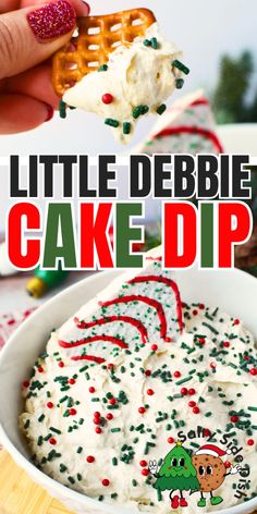 a hand holding a piece of cake dip with sprinkles and candy canes