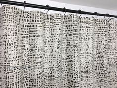 a white curtain with black dots on it