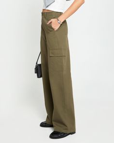 Product Details The Clem Pant offers a relaxed fit and mid-rise for effortless style. The wide leg design provides a cool and comfortable fit, perfect for any casual occasion. With cargo pockets and an olive green color, these pants are both functional and fashionable. - Front button and zipper- Pockets- Lightweight fabric- Content: 100% Cotton; Lining: 80% Polyester, 20% Cotton- Care: Wash cold & tumble dry low Style# C24WPAH02820 Fit Notes - Model wearing a size 2- Model measurements: 5'10'' H Olive Green Color, Leg Design, Model Measurements, Lightweight Fabric, Green Color, Effortless Style, Olive Green, Mid Rise, Comfort Fit