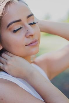 a woman with her hand on her neck