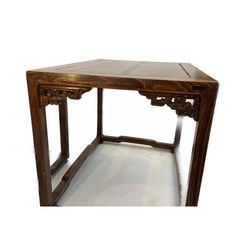 an old wooden table with carvings on the top and bottom edge, against a white background