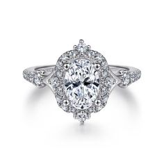 an oval cut engagement ring with halos and pave diamonds