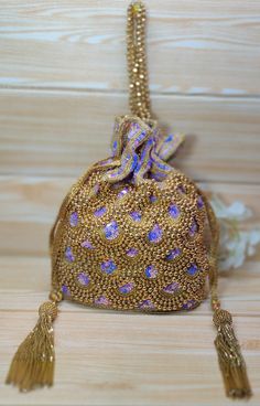 Indian Golden purple Color Women Fashion Handmade Potli Bag, Ethnic Wedding hand bag, Bridal Bag Embellished With Beads & Sequins Potli Bag  Dimensions: Length: 8.5 inches Width: 7.0 inches Depth: 8.0 inches This Handmade Beaded potli bag is good match for beautiful Women with both Indian wedding and Festivals.  The bag is embellished with high quality semi-precious stones like pearls, beads, crystals, sequins on a beautiful high quality fabrics. Two drawstrings at both ends give our Potly bag a stunning look. Wrist handle studded with beads.  This Hand Pouch would be best complement to your designer saree, lehanga or any other kind of Western Wear dress. The ideal gifts for your daughters, mothers, grandmothers, colleagues, partners, students, and girlfriends. Each of our products is havi Gold Potli Bag With Latkans For Reception, Festival Potli Bag With Latkans For Reception, Traditional Bags With Latkans For Reception, Traditional Embellished Pouch Bag, Festival Reception Potli Bag With Latkans, Festive Embellished Pouch Shoulder Bag, Festive Potli Bag With Latkans For Receptions, Festive Beaded Handheld Bags, Rectangular Embellished Potli Bag For Festivals