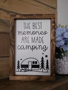 the best memories are made camping sign next to hydrant and vase with blue flowers