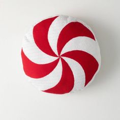 a red and white peppermint candy cane on a white background