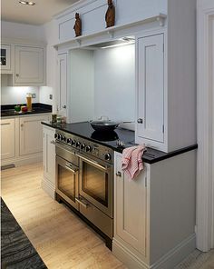 a kitchen with an oven, stove and cabinets