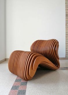 a wooden bench sitting on top of a tiled floor