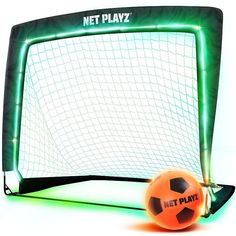 an orange soccer ball sitting in front of a net with neon lights on it's sides