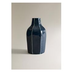 a blue vase sitting on top of a white table