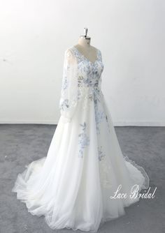 a white dress with blue flowers on it