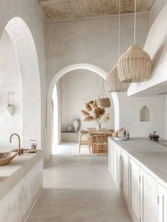 a large kitchen with white walls and counters