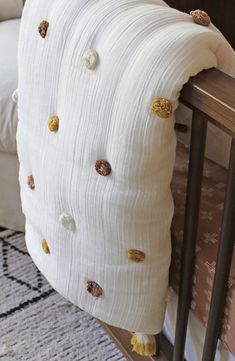 a white pillow sitting on top of a wooden bed