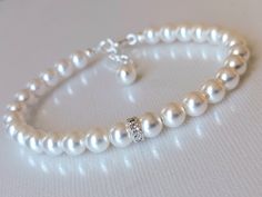 Wedding White Pearl Silver One Strand Classic Style Dainty Bridal Bracelet. BRACELET is about 7.20 inches (18.3cm) long plus 1 inch extender chain. BRIDAL EARRINGS SECTION: https://www.etsy.com/shop/LanaChayka?ref=seller-platform-mcnav§ion_id=11638940 BRIDAL JEWELRY SETS SECTION: https://www.etsy.com/shop/LanaChayka?ref=seller-platform-mcnav§ion_id=25839214 BRIDAL NECKLACES SECTION: https://www.etsy.com/shop/LanaChayka?ref=seller-platform-mcnav§ion_id=11638944 Elegant and simple, this stunning b Adjustable White Bracelets For Wedding, Adjustable Round Pearl Bracelet For Wedding, Classic White Bracelets For Wedding, Elegant Adjustable Bridal Accessories For Marriage, Classic White Wedding Bracelets, Adjustable Pearl Crystal Wedding Bracelet, Adjustable Round Crystal Bracelet For Wedding, Adjustable Pearl Crystal Bracelet For Wedding, White Round Pearl Bracelet For Wedding