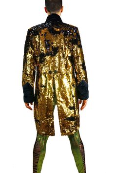 Every man needs a secret weapon in their closet. So, we made this mens black and gold sequin jacket to be the ultimate crowd pleaser. A classic silhouette with a glittery disco twist. Each of our sparkly tuxedo tailcoats is tailored to perfection and guaranteed to make you the life of the party. FEATURES: Shiny black and gold sequins that change colors when you touch them Black velvet cuffs and lapels Contrasting gold piping Blazer in front with tails in back Signature art deco satin lining Matt Gold Sequin Blazer, Gold Sequin Jacket, Festival Jacket, Sequin Blazer, Mens Formal Wear, Streetwear Shop, Sequin Jacket, Carbon Neutral, Tuxedo Jacket