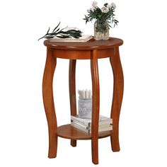 a small wooden table with flowers and books on it