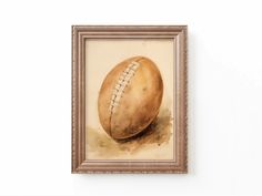 a painting of a football in a frame on the wall above it is a watercolor drawing