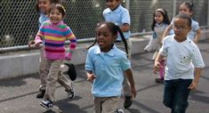 several children are walking down the street together