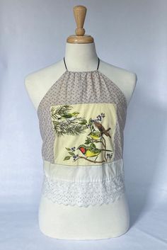 Vintage textile bird design halter top with white lace hem. Spring Lace Patchwork Sleeveless Crop Top, Spring Sleeveless Lace Patchwork Crop Top, Sleeveless Lace Patchwork Crop Top For Spring, Spring Sleeveless Patchwork Crop Top, Patchwork Tank Top For Beach In Spring, Sleeveless Summer Crop Top With Patchwork, Spring Halter Neck Lace Top, Summer Cotton Tops With Bird Print, Spring Cotton Tank Top With Patchwork