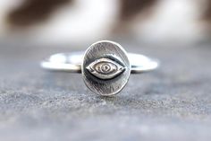 This listing is for detailed sterling silver Evil Eye ring. The eye focal piece is hand forged from steel dies and fired onto sturdy 14 gauge sterling silver wire.  Wear this ring solo or wear it stacked with several hammered bands for an edgier, bohemian style! Perfect gift for any witchy woman! - Choose your ring size and stacking options at checkout!  - Eye focal measures approximately 8mm by 9mm. - Ring band measures 1mm. - Made to Order: please see current processing times in Shipping Info Evil Eye Jewelry Silver, Silver Eye Ring, 9mm Ring, Witch Ring, Eye Ring Silver, Evil Eye Ring Silver, Witch Rings, Silver Eye, Hammered Band