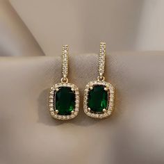 * New Emerald Green Crystal Elegant Square Gold Cubic Zirconia Diamond Earrings * Boutique Item * Unique, Delicate, And Trendy * Color: Gold * High Quality Materials And Premium Plating Process * All Jewelry Items Come With A Cleaning / Ponishing Cloth * Bundle And Save! Other Listings: Silver Gold Pearl Necklace Earrings Bracelet Engagement Ring, 925 Sterling Silver, S925 Silver, Vintage Style, Modern, Punk, Chunky, Minimal, Simple, Classic, Trendy, 925 Gold Ring, Adjustable Open Ring, Cute, Ch Emerald Earrings Drop, Diamond Drop Earrings, Art Deco Earrings, Emerald Earrings, Diamond Drops, Crystal Drop Earrings, Rhinestone Earrings, Green Crystals, Pearl Drop Earrings