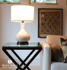 a lamp sitting on top of a table next to a couch