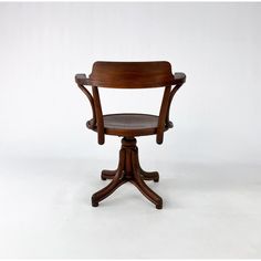 a wooden chair sitting on top of a white floor