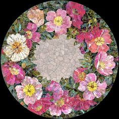 a circular mosaic design with flowers in the center