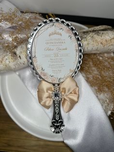 a table setting with an ornate frame and ribbon