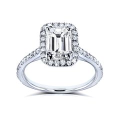 an emerald cut diamond engagement ring with pave set diamonds on the shoulders and sides