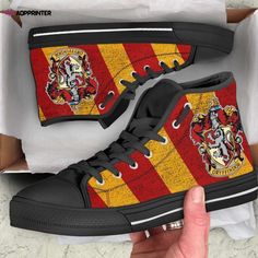 harry potter high top shoes with hog potter crests on them