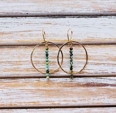 Handmade hammered hoop earrings with drop bar turquoise beads. Crafted with gold filled metal and ear wires. Made with only high-quality materials and craftsmanship. For those who love unique classic everyday designs. Super lightweight . Perfect for summer! Dimensions: The earrings are approximately 1.5" long from ear wire to bottom of turquoise bar and are approximately 1" wide at widest point Each pair is handmade, slight variations may occur. Please feel free to ask any questions! Thanks for Anthropology Earrings, Beaded Wire Earrings, Copper Earrings Handmade, Wire Earrings Handmade, Earring Inspo, Turquoise Bar, Turquoise Hoop Earrings, Turquoise Hoops, Earrings Ideas