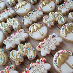 decorated cookies are arranged on a table with the words happy birthday written in gold letters